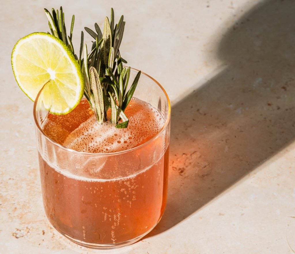 Olmec tequila cocktail garnished with lime and rosemary