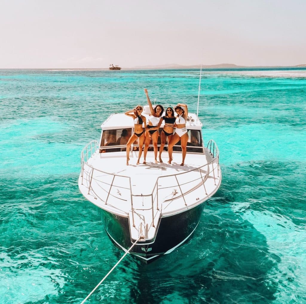 group of girls on a yacht party with tequila olmeca