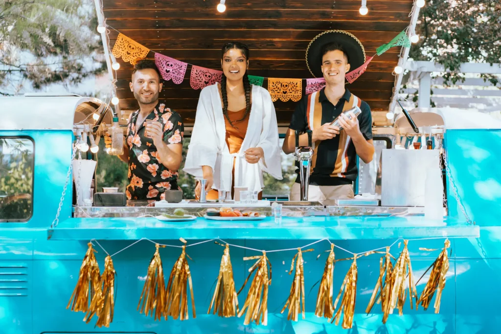 people in a mobile bar preparing olmeca tequila shots for the mexican party