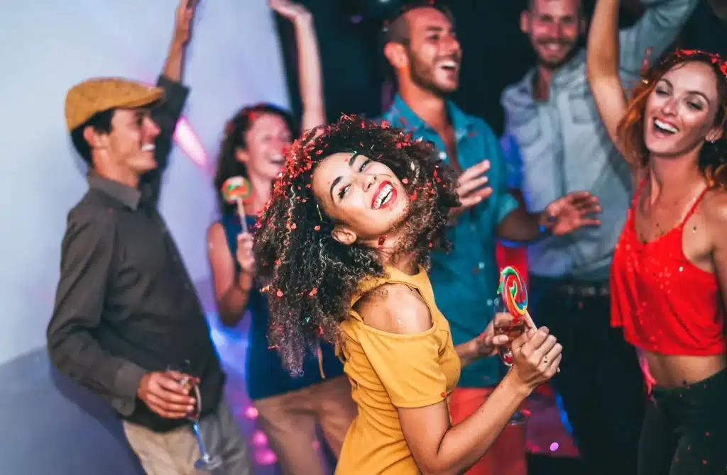 Group of friends at a party enjoys dancing while smart drinking