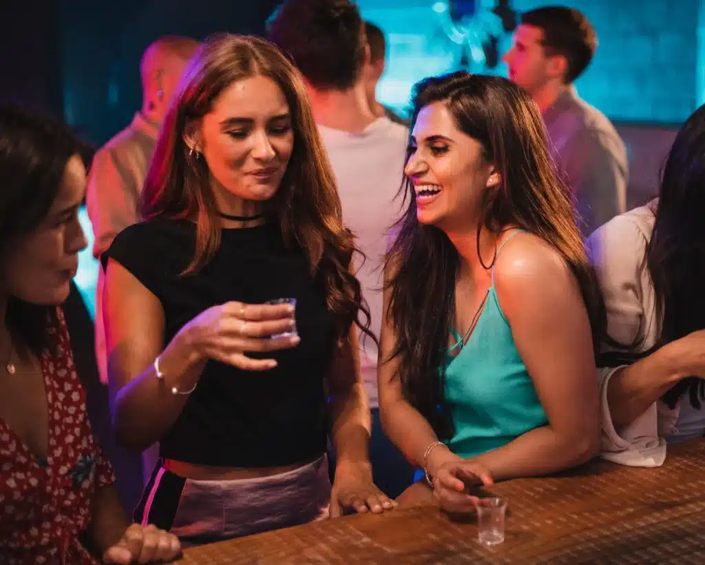 group of friends take a shot of olmeca tequila at a Mexican party