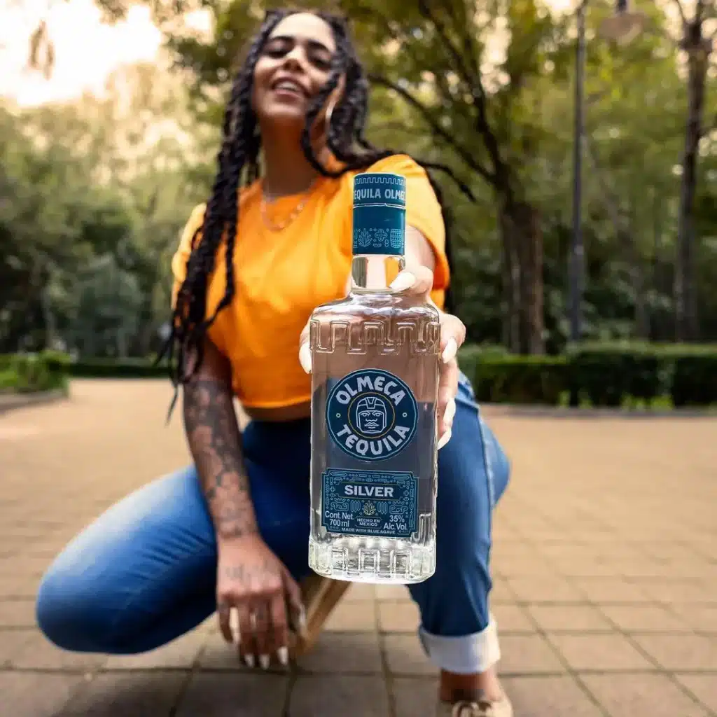 Woman enjoying with her partner Valentine's Day out of the ordinary with a bottle of Olmeca Silver tequila
